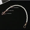 A close-up of an elegant pearl strap for handbags showing various measurements and a gold clasp.