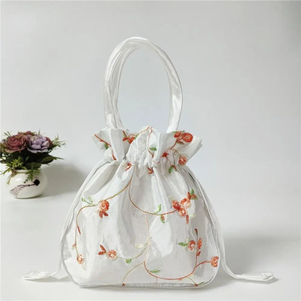 Clutch de noche con lazo de purpurina blanca y bordado floral