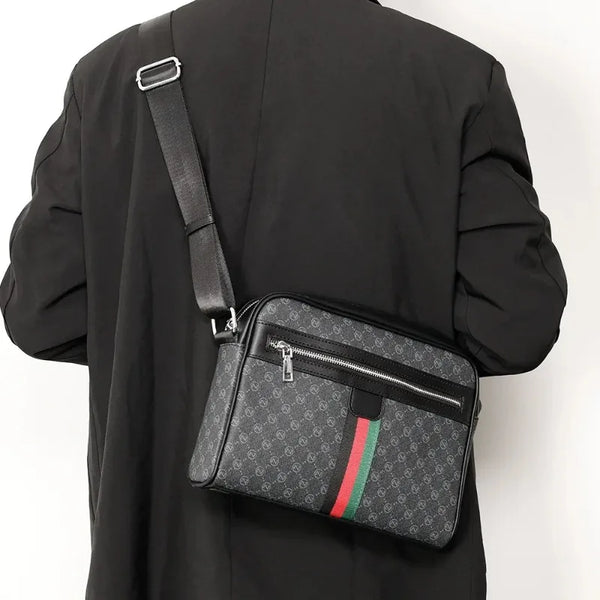 Black men's letter print crossbody sling bag worn on a black jacket.