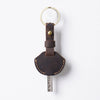 A brown leather key fob cover with a metal ring and a key attached.