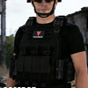 A tactical vest worn by a man, featuring multiple pouches and a quick-release system.