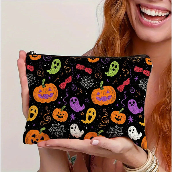 A black makeup pouch featuring a colorful pumpkin pattern with Halloween-themed designs.