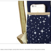 A dark blue canvas backpack with a tan strap and a front pocket decorated with white stars.