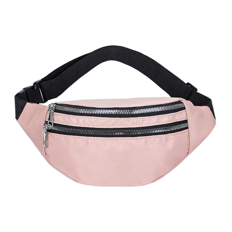 A light pink nylon crossbody sling bag with a black adjustable strap and zipper.