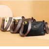 A collection of brown and black luxury PU leather crossbody handbags with gold hardware displayed on a light beige background