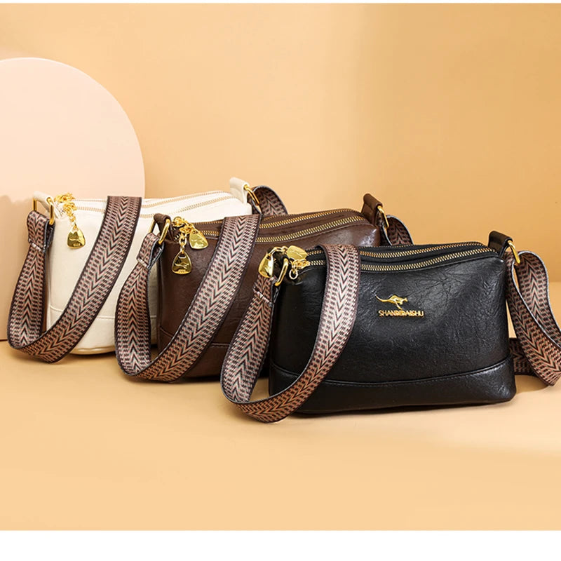 A collection of brown and black luxury PU leather crossbody handbags with gold hardware displayed on a light beige background