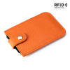 An orange genuine leather slim card holder with a black lining and RFID protection feature.