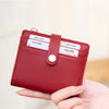 A close-up of a red leather minimalist wallet with RFID blocking features and cards inside.