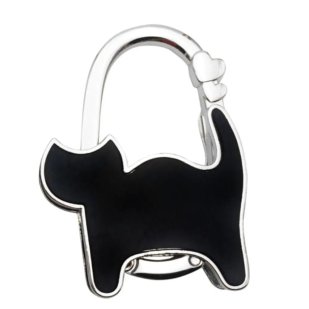 Silver hoop shaped like a black cat silhouette used as a portable handbag hook