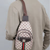 A man wears a beige jacket with a brown leather strap attached to a patterned, personalized printed crossbody sling bag.