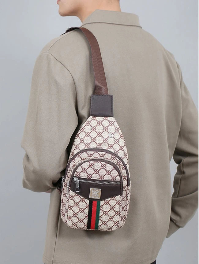A man wears a beige jacket with a brown leather strap attached to a patterned, personalized printed crossbody sling bag.