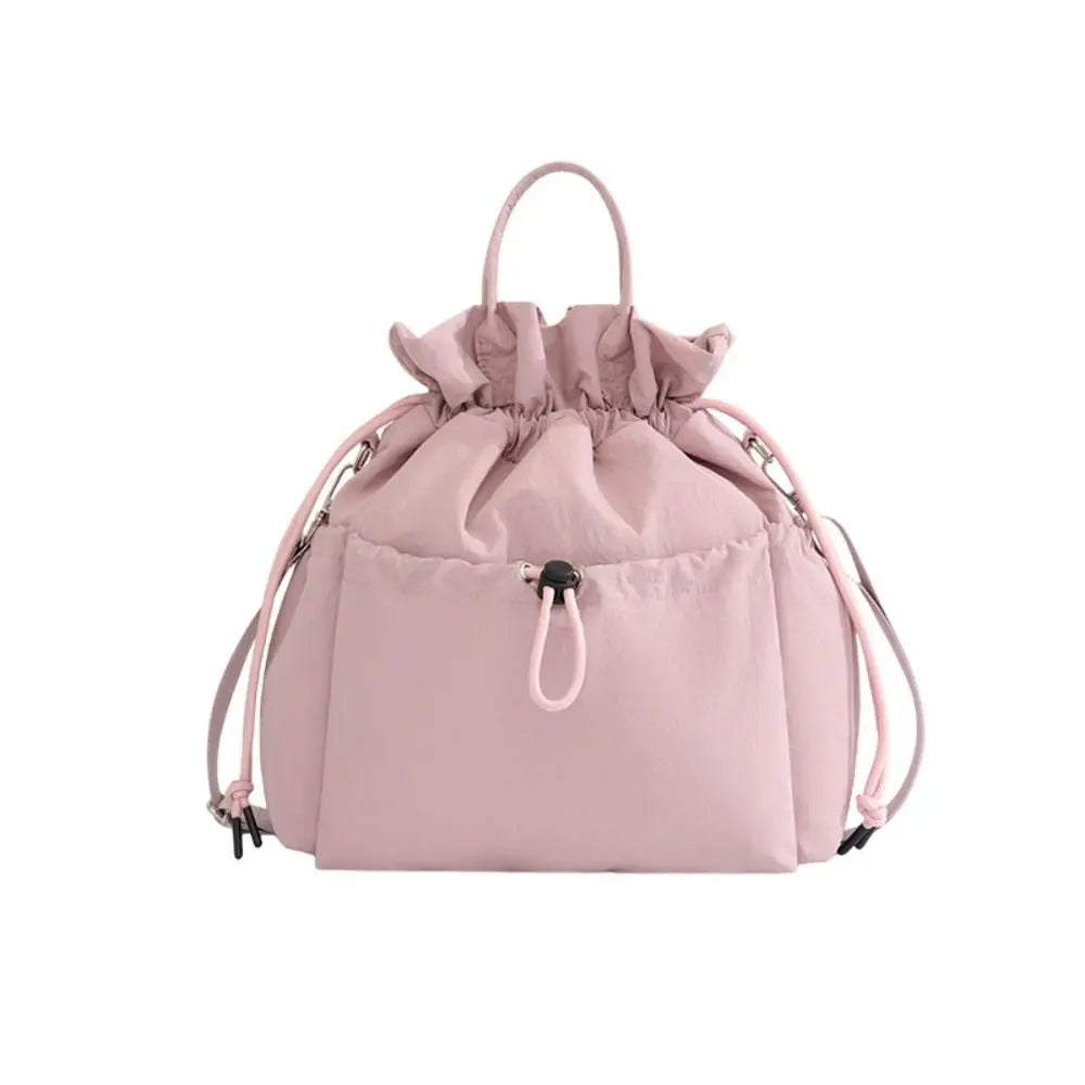 A pink insulated waterproof lunch bag with a drawstring closure.