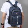 A man is wearing a dark blue lightweight commuter backpack with orange accents and a black face mask.