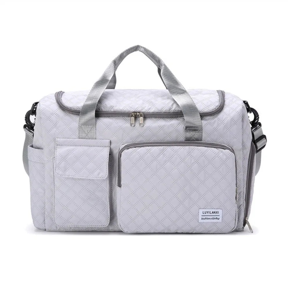 A light gray quilted portable travel duffle bag with padded compartments and carrying handles.