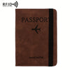 A brown leather passport holder with a black stripe and a silhouette of an airplane.