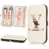 A beige cosmetic case holds a stainless steel nail clipper set and a large cardholder featuring a personalized initial Y and 