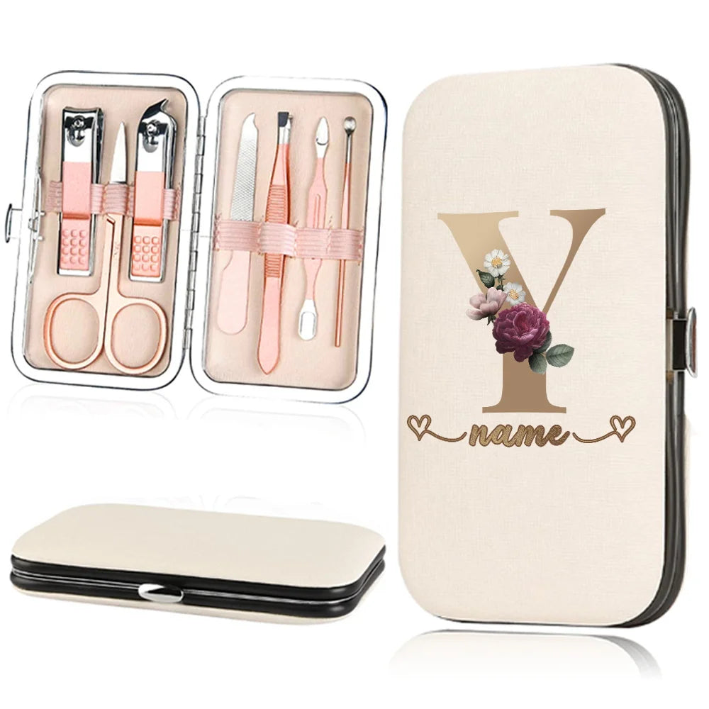 A beige cosmetic case holds a stainless steel nail clipper set and a large cardholder featuring a personalized initial Y and 