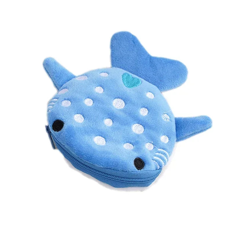 A small blue shark plush coin purse wallet with a zipper and a heart detail.