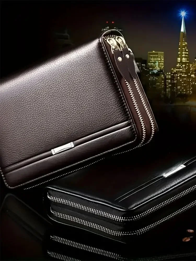 A dark brown leather mens long zipper wallet clutch with silver accents shown in a close-up view.