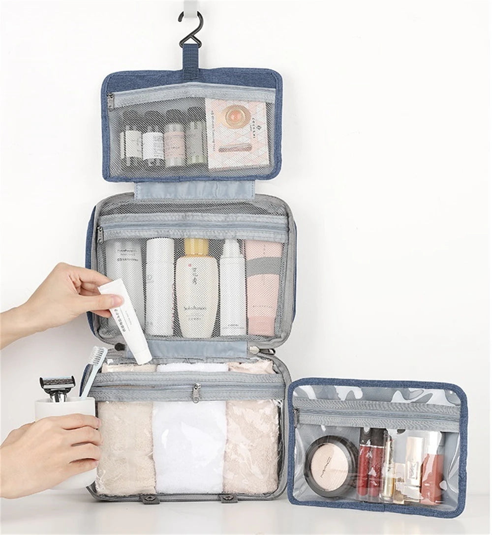 A blue toiletry bag with a hanging hook is shown open, displaying various skincare and cosmetic products.