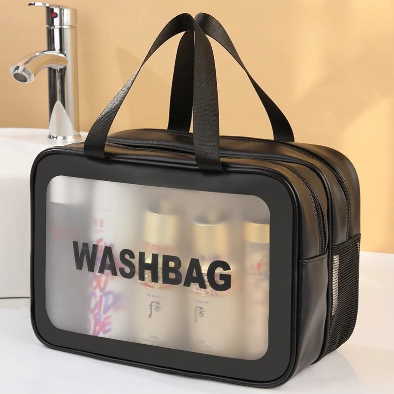 A black double-layer clear and dry wash bag with black straps is shown on a white surface.