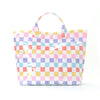 A colorful checkered striped tote bag with pink, purple, yellow, and blue squares.