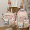 A pink Kawaii Harajuku backpack with a laptop compartment and light blue accents being held by a person.