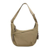 A tan canvas crossbody bag with a drawstring closure is shown against a white background.