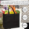 A black reusable grocery tote bag made of non-woven polypropylene being held by a person.