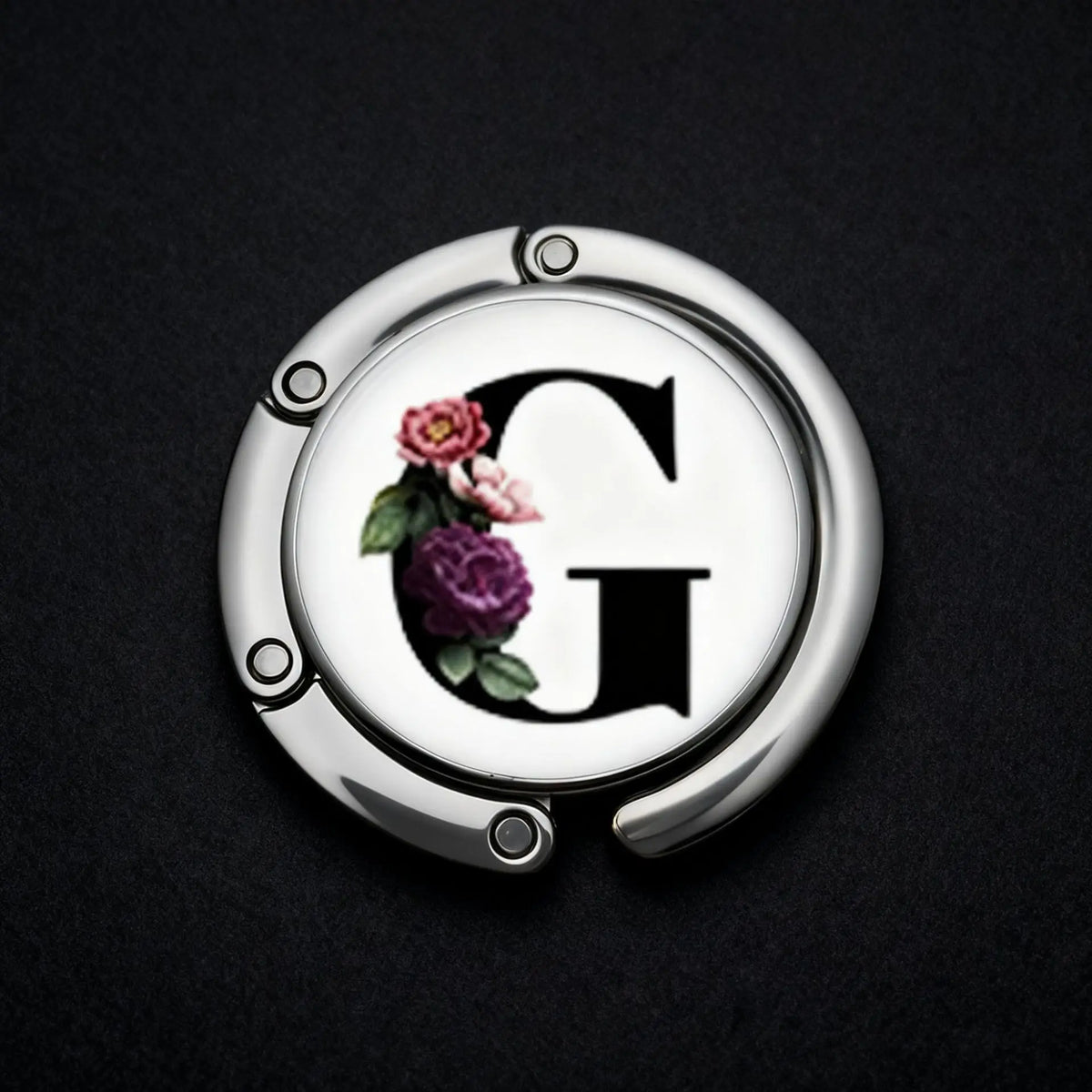 Silver foldable letter hanger hook with a decorative floral design on the surface