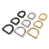 A collection of various D-shape metal spring ring clasps in black and gold finishes.