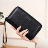A black slim RFID-blocking PU leather wallet with a zipper closure is held in a hand.