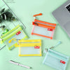 A set of clear mesh bags in yellow and orange for storing coins and cards, displayed on a light green surface.