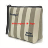 Bolsa cosmética beige con rayas grises y el logo original de SB 'Dreaming of Winter Paradise'