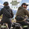 A man wearing a tactical sling crossbody waist pack while riding a motorcycle in an outdoor setting.