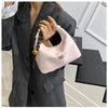 A light pink retro PU leather shoulder bag with a gold chain strap is shown being held by a woman wearing a gray blazer.
