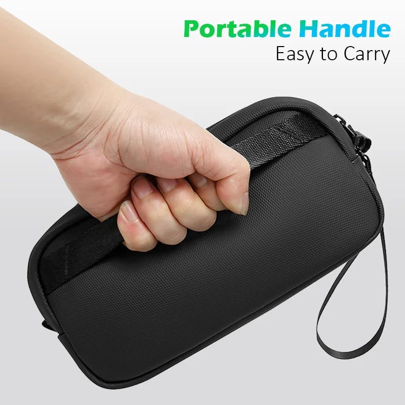 A hand is holding a black portable handle organizer pouch for easy carrying.