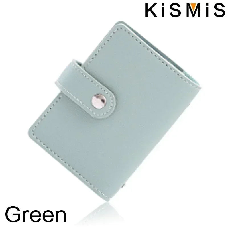 A light green slim leather card holder with a silver accent, shown at an angle.