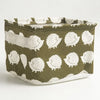 A woven storage basket made of olive green and white fabric with a textured pattern.