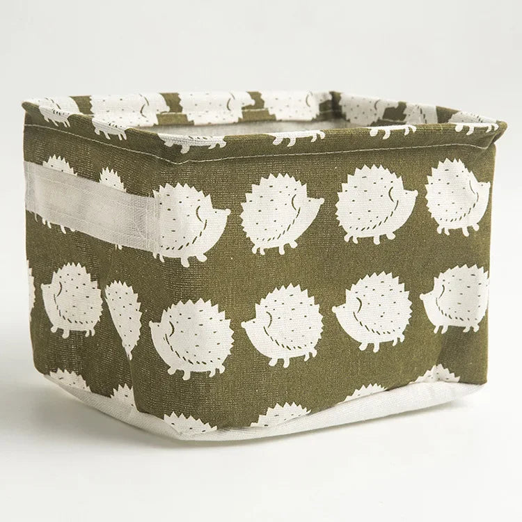 A woven storage basket made of olive green and white fabric with a textured pattern.