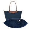 A navy blue felt organizer insert designed to fit into a handbag.