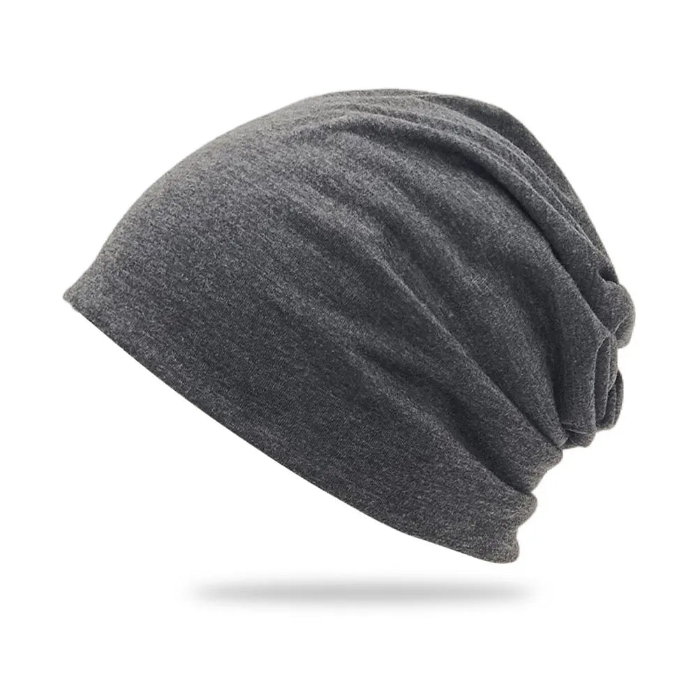 A dark gray slouchy knit beanie hat shown from the side.