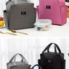 A collection of gray and pink insulated canvas tote bags with various sizes and a clear container.