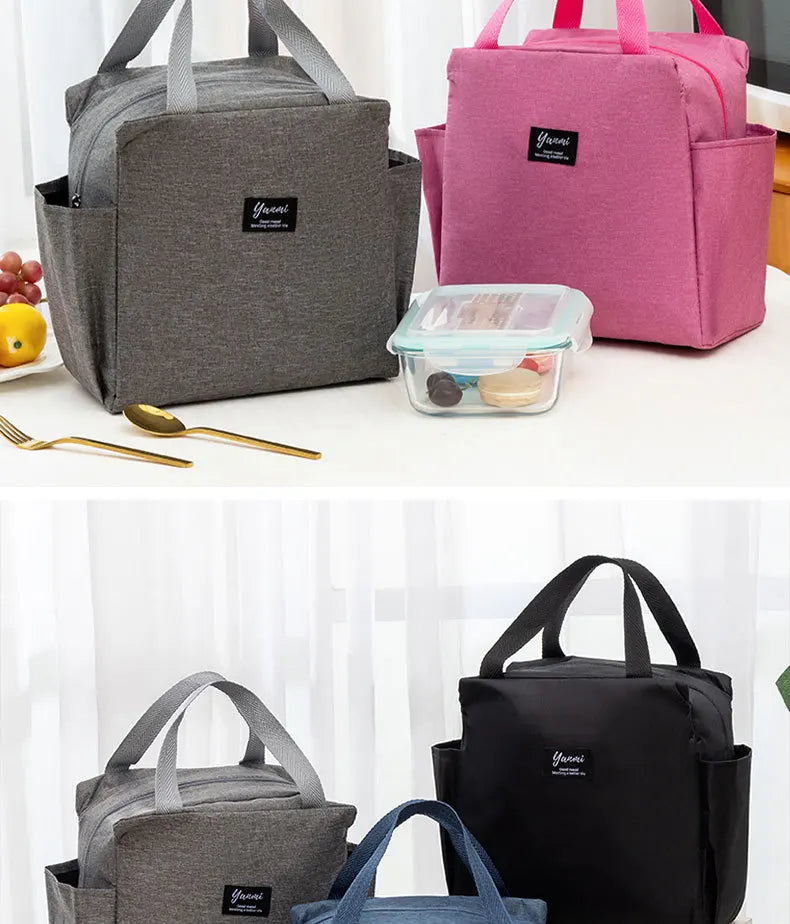 A collection of gray and pink insulated canvas tote bags with various sizes and a clear container.