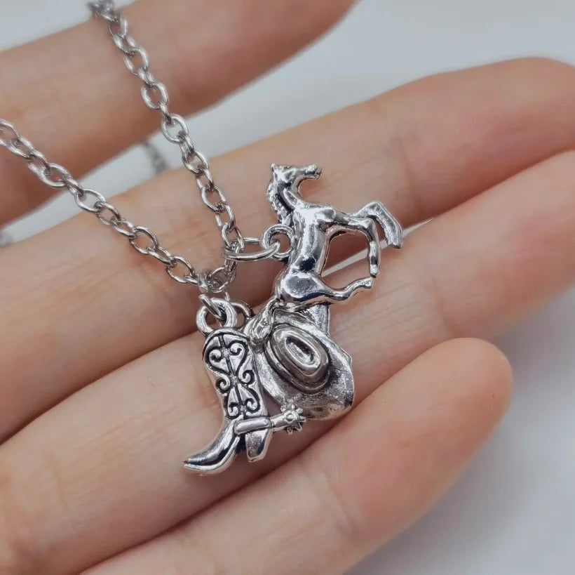 Silver necklace featuring a detailed Western cowboy boot and hat horseshoe charm