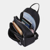 A black waterproof women's travel backpack with a zippered compartment open, showing various items inside.