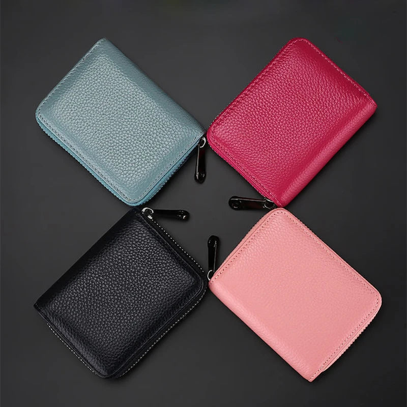 Four classic zipper card holder wallets in pastel colors: mint green, pink, black, and light pink.