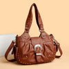 Braune Vintage Soft PU Leder-Schultertasche mit silberner Hardware auf hellem Hintergrund.