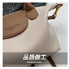 A light beige vintage PU leather crossbody handbag with brown leather trim and gold hardware.