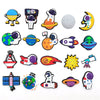 A collection of decorative shoe charms and pins featuring various space-themed designs like planets, rockets, and astronauts.